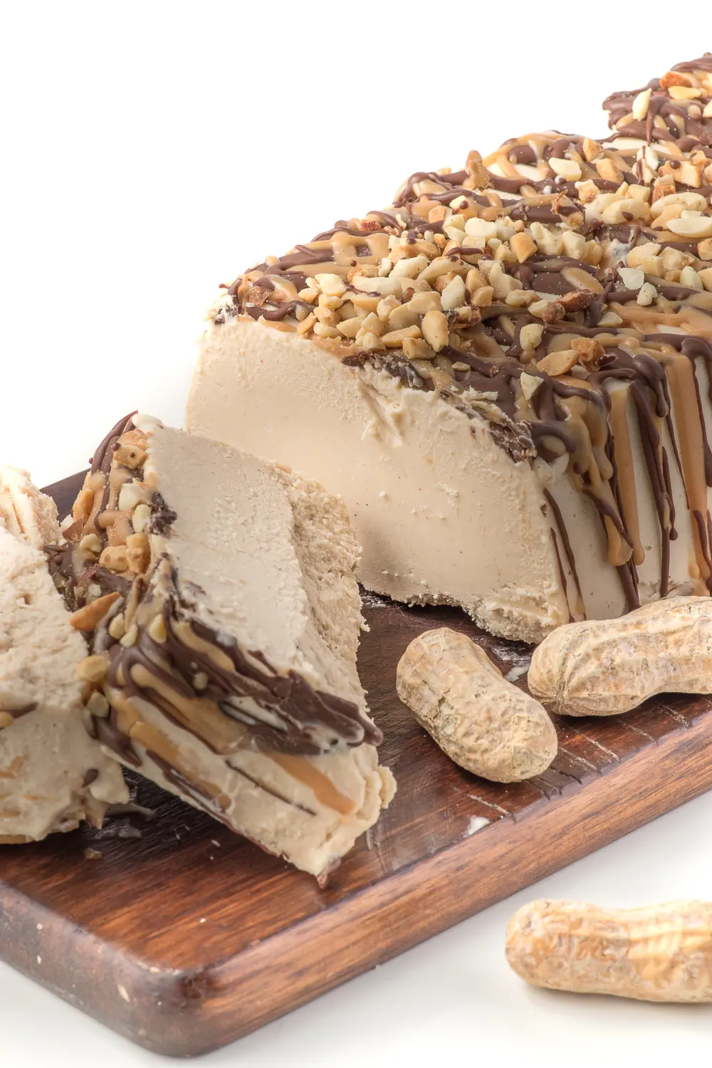 a loaf shaped peanut butter ice cream cake sliced on a cutting board