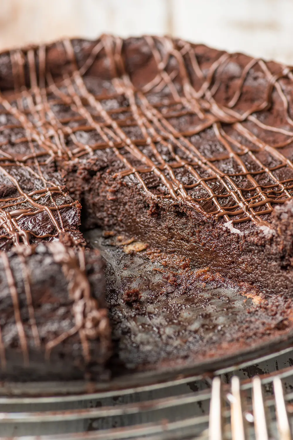chocolate torte with a piece removed, up close shot to show the inside fudgy texture 