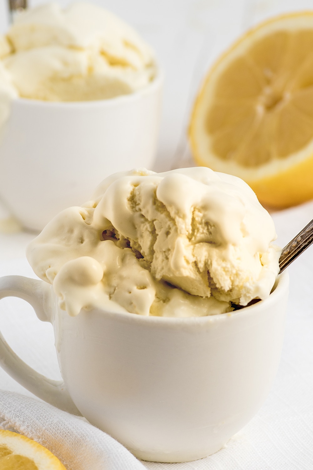 A small cup of creamy lemon gelato melting