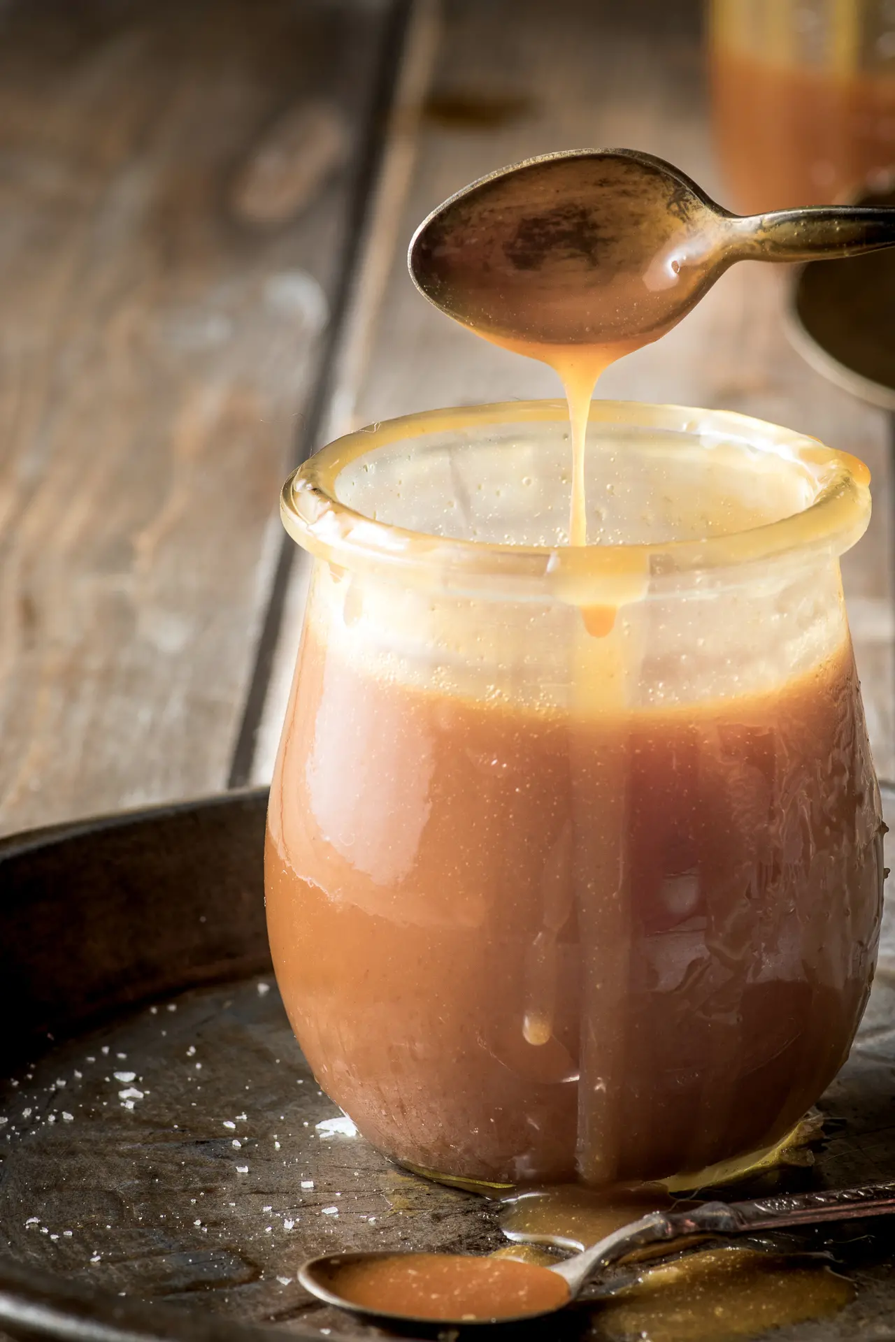 Low carb caramel sauce dripping from a spoon.