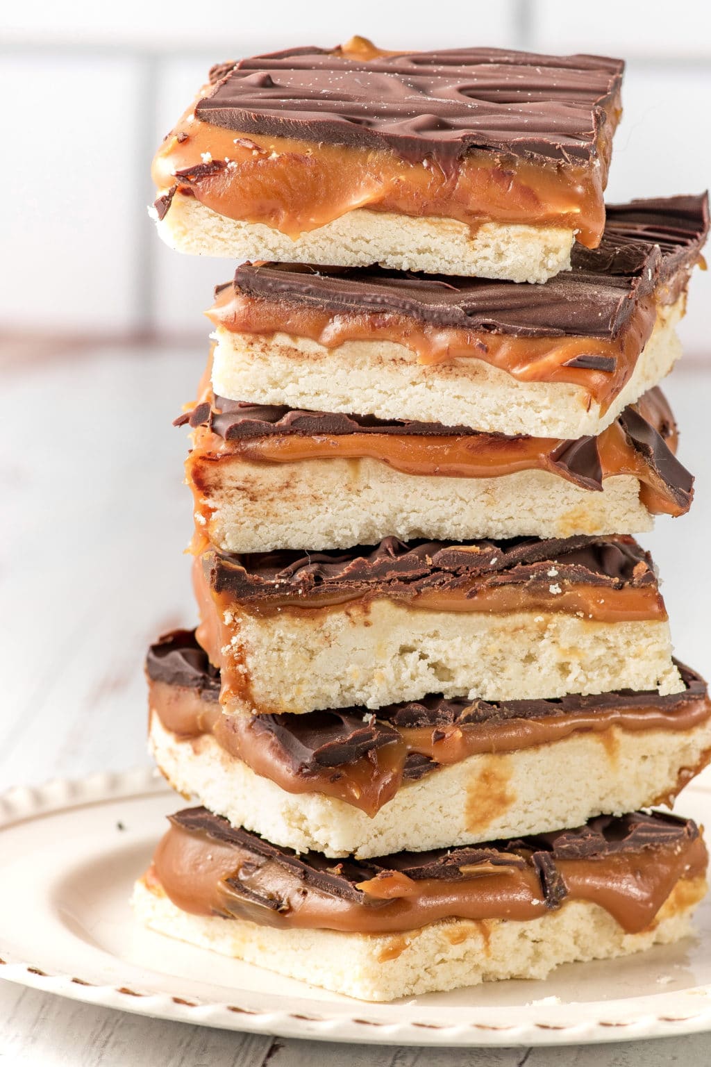 A stack of keto-friendly millionaire bars stacked on a white plate