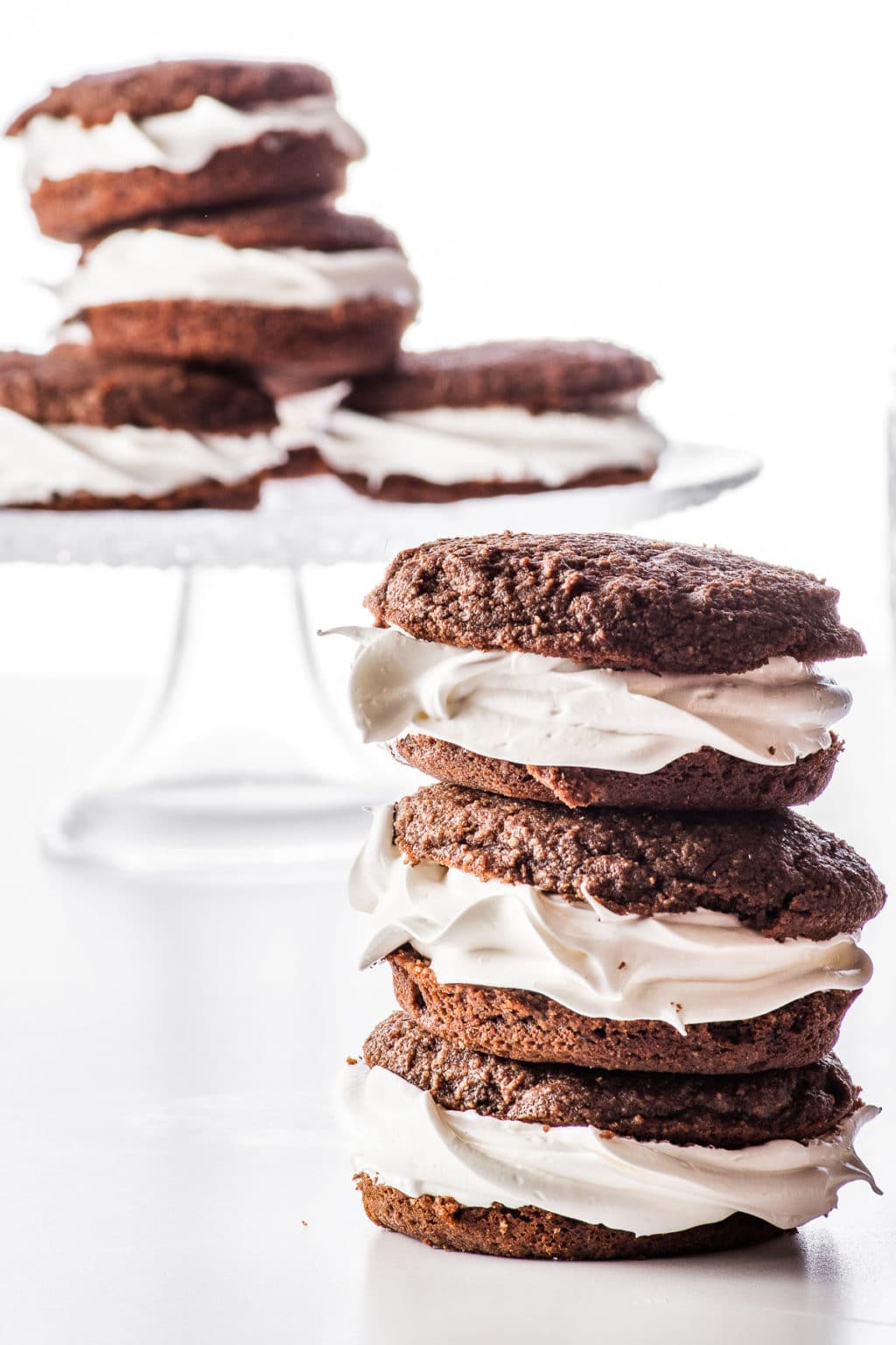 Stacked chocolate low carb whoopie pies on a bright white background
