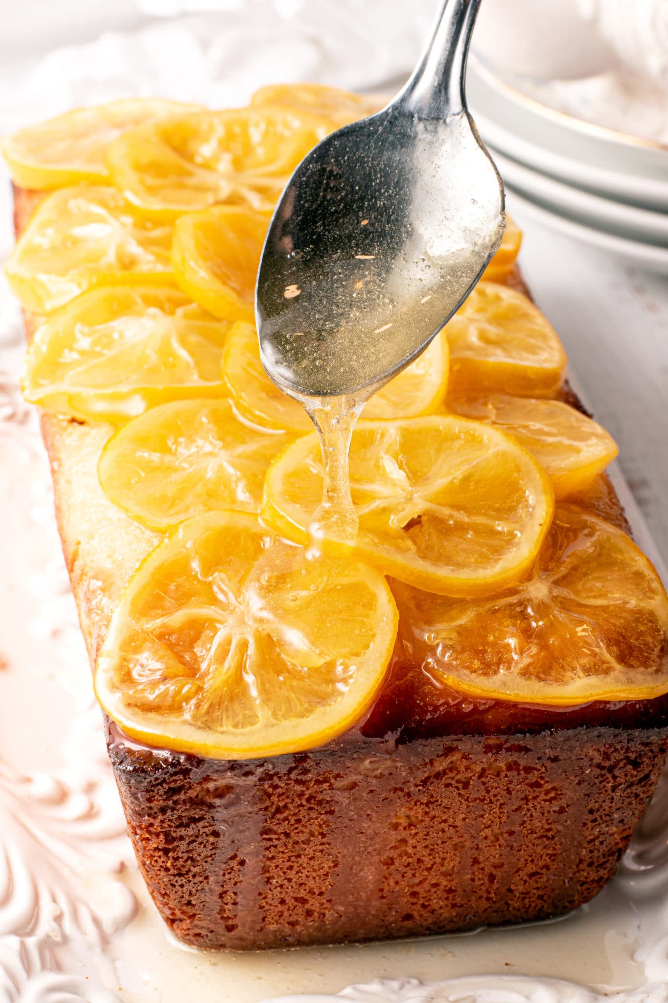 Syrup being drizzled over the candy lemons on the cake.