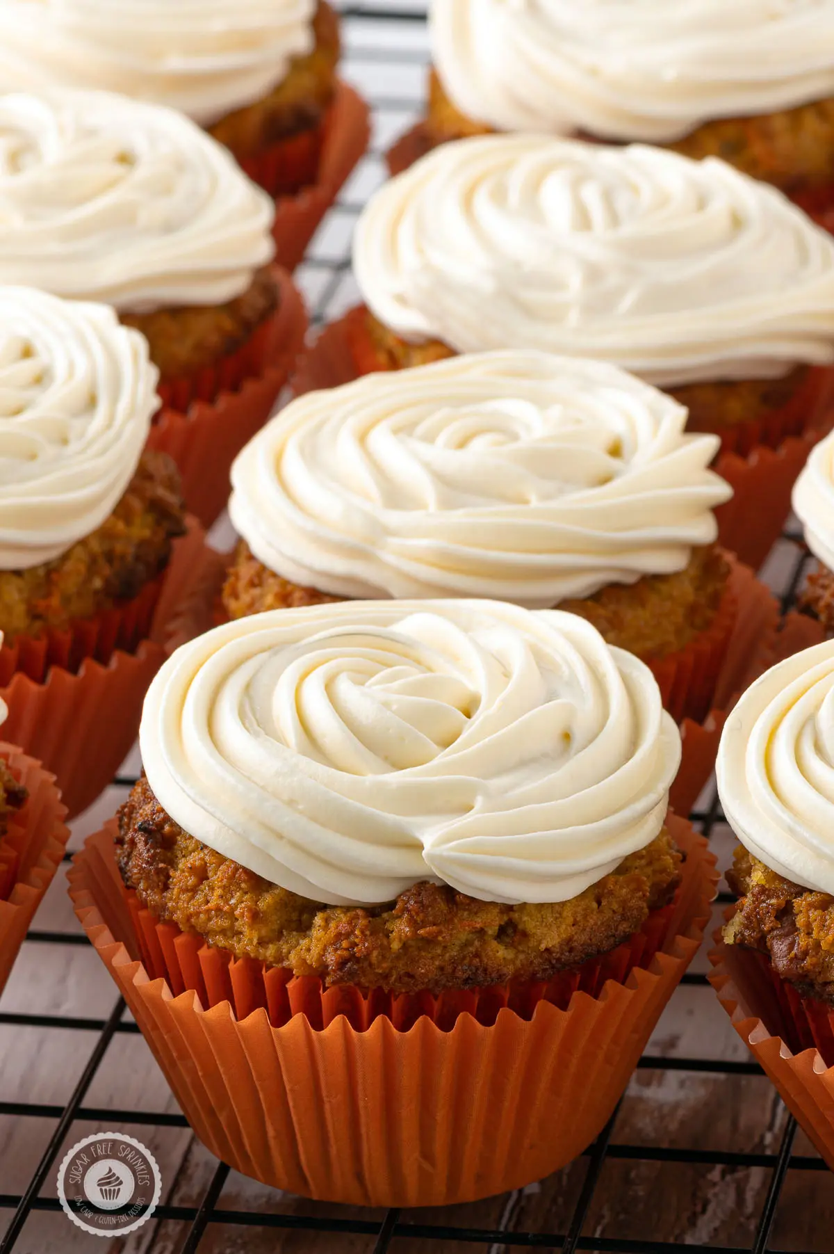 Stacks of freshly baked muffins with perfect swirls of cream cheese frosting 