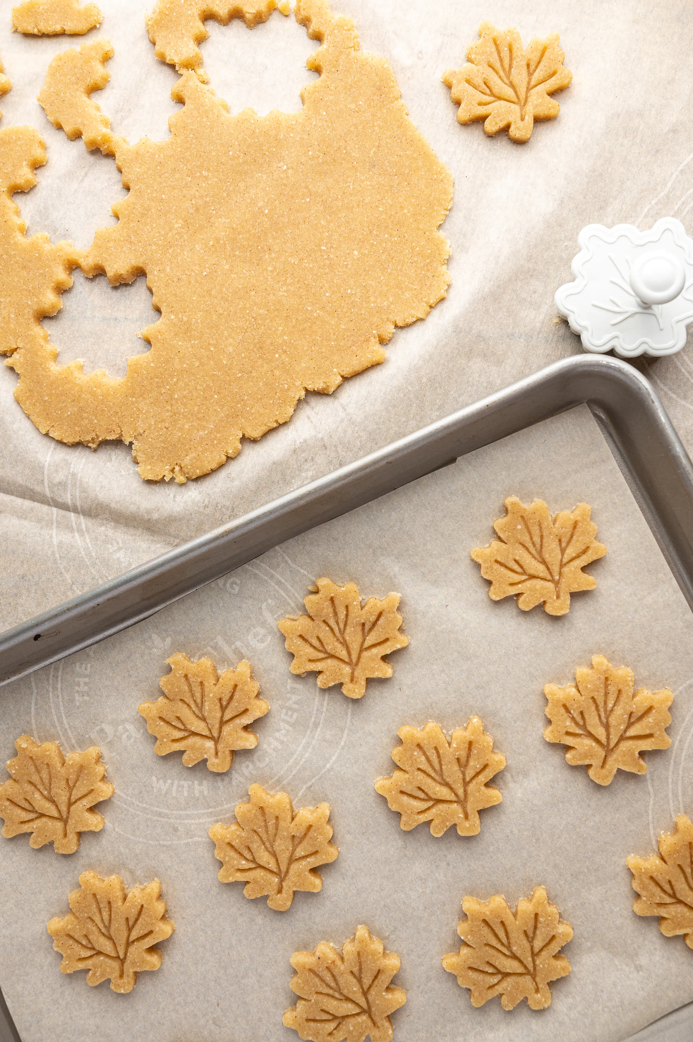 Cookie tray of unbaked maple leaf shaped pie decorations