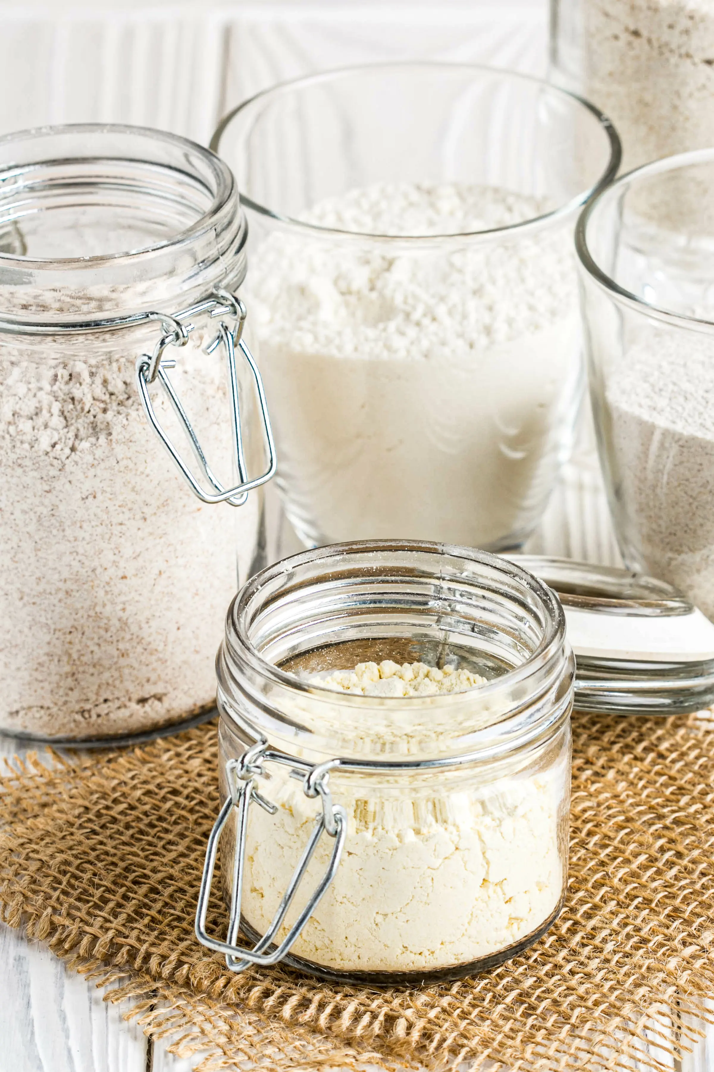 Different  low carb flour in glass jars, almond, coconut