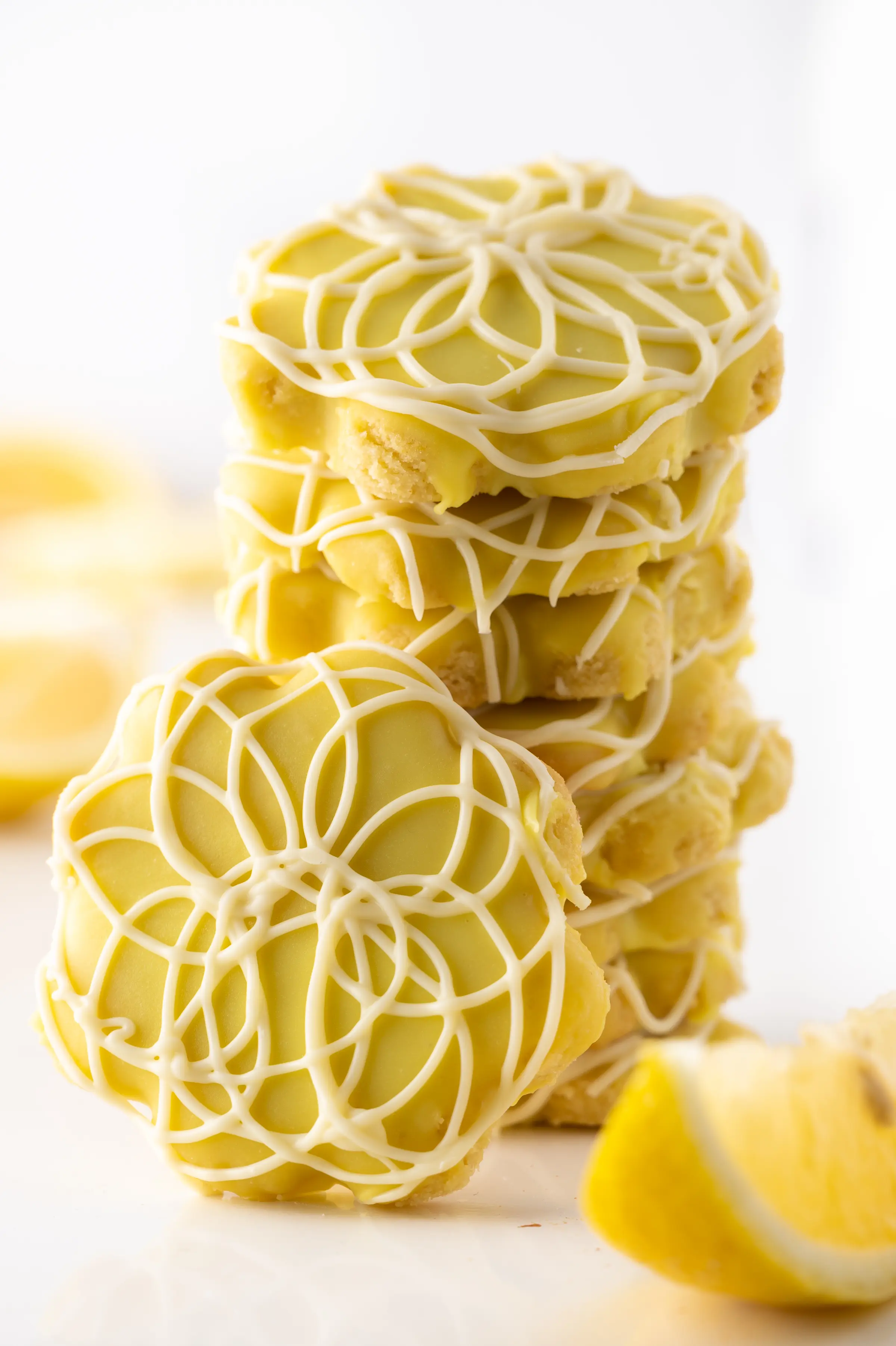 A stack of low carb lemon cookies on againss a bright white background. 