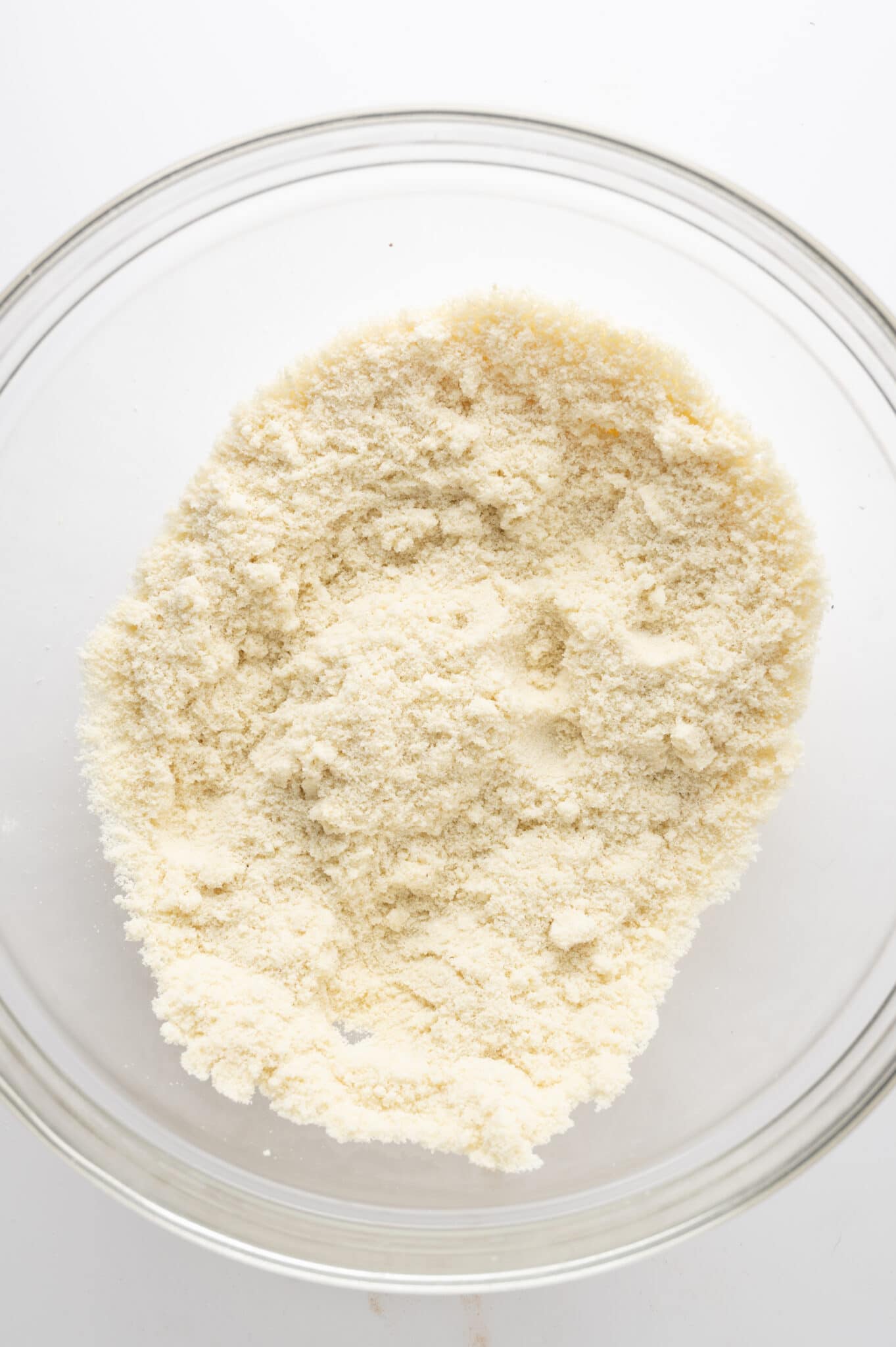 Dry ingredients in a clear bowl against a bright white background.