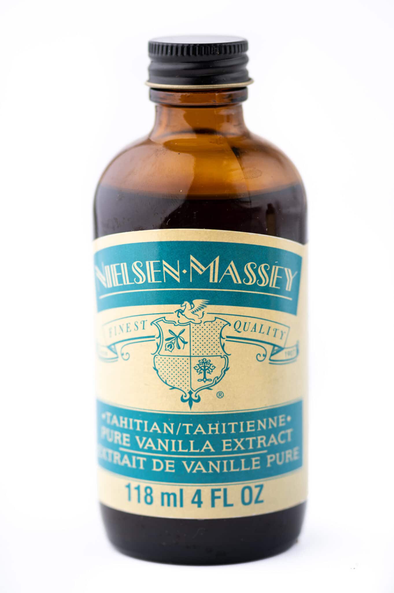 A bottle of Tahitian vanilla with a blue label against a bright white background.