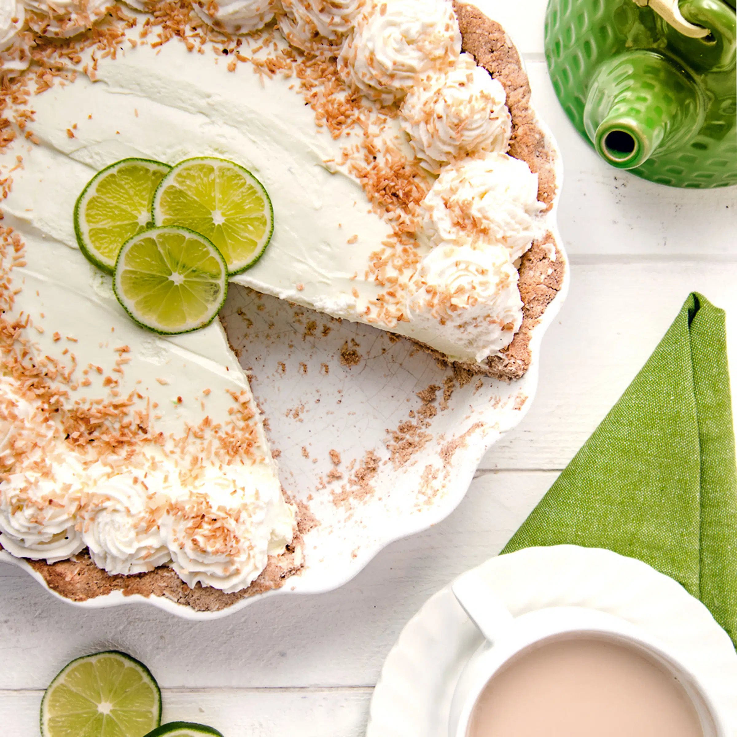 A sugar free key lime pie with a slice taken from it.